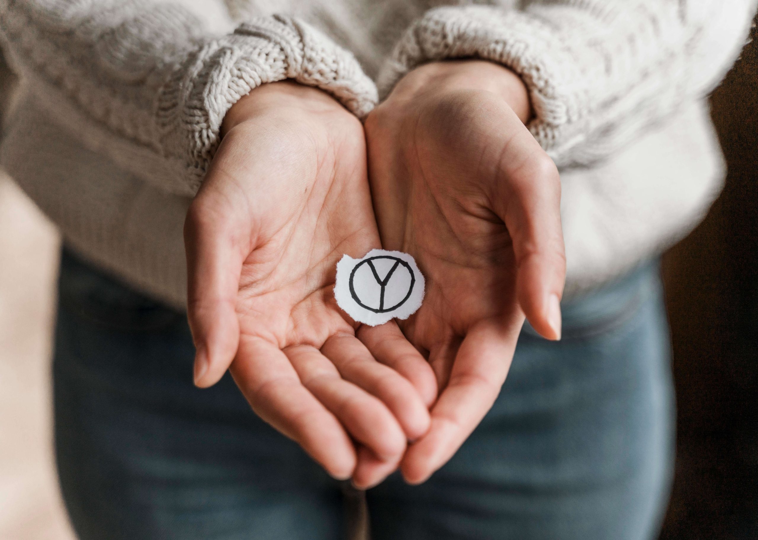 close-up-woman-holding-peace-sign